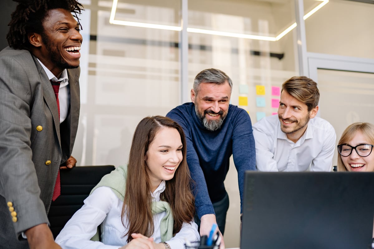 A Happy Team Looking at a Laptop